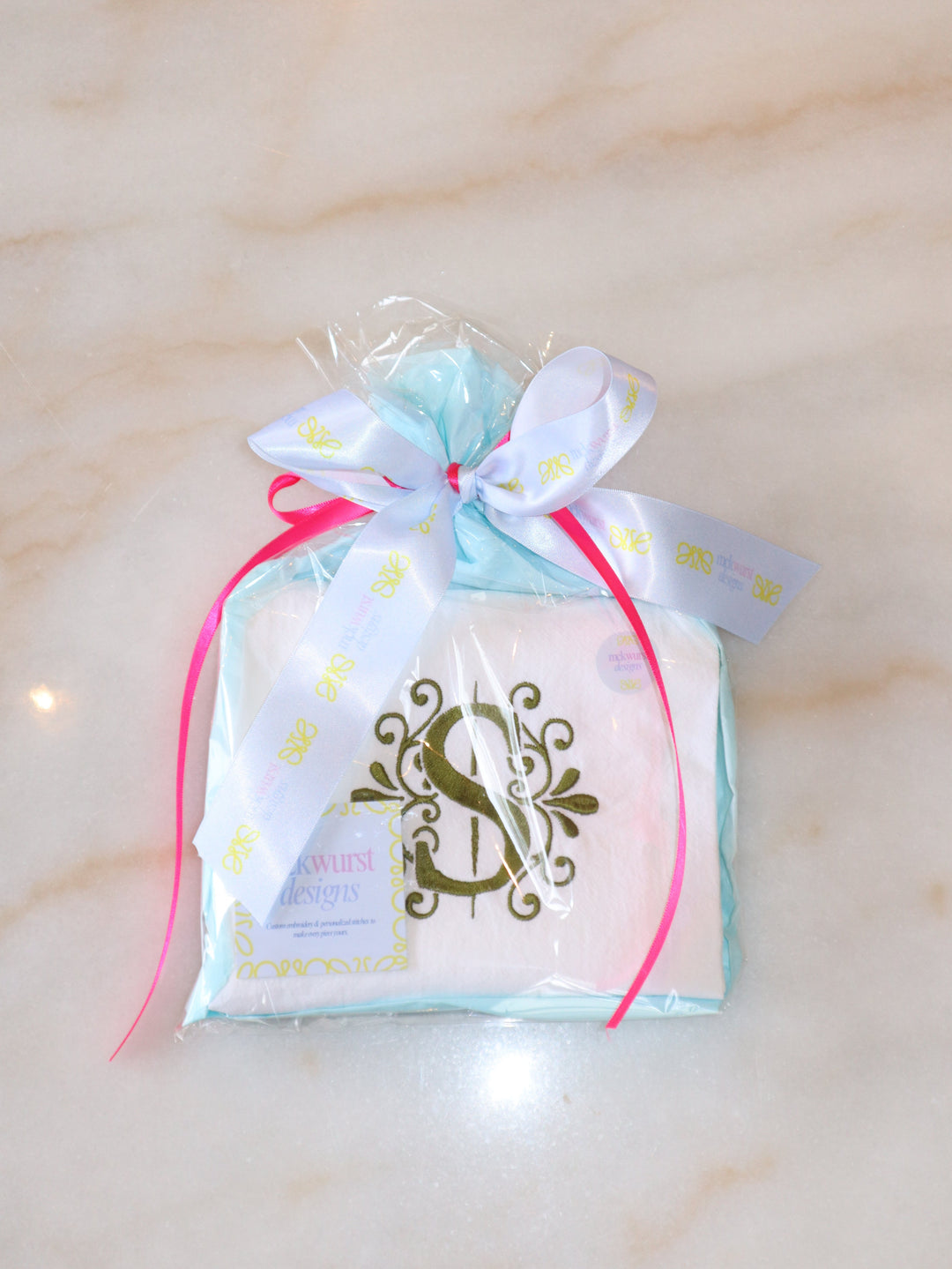 Product packaging with a decorative bow on a light background